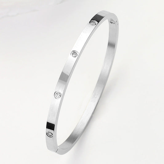 Madeline Love Silver Stainless Steel CZ Stone Embellished Bangle Bracelet - Bracelets