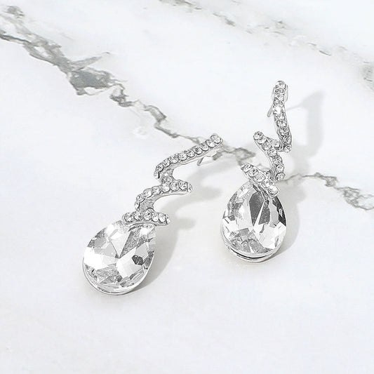 Madeline Love Clear, Silver Teardrop Glass Stone Drop Stone Paved Swirl Evening Earrings