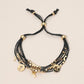 Madeline Love Black, Gold Cross Charm Beaded Multi Layered Cord Adjustable Cinch Pull Tie Bracelet - Bracelets - desc