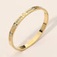Madeline Love Gold Stainless Steel CZ Accent Quatrefoil Engraved Hinged Bangle Bracelet - Bracelets