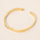 Madeline Love Gold Stainless Steel CZ Accent Quatrefoil Engraved Hinged Bangle Bracelet - Bracelets - extra