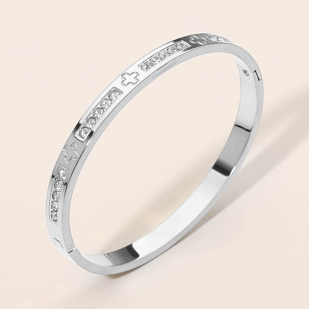 Madeline Love Silver Stainless Steel CZ Accent Quatrefoil Engraved Hinged Bangle Bracelet - Bracelets