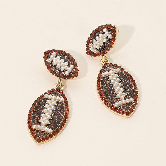 Madeline Love Brown, Gold Rhinestone Pearl Embellished Football Dangle Earrings