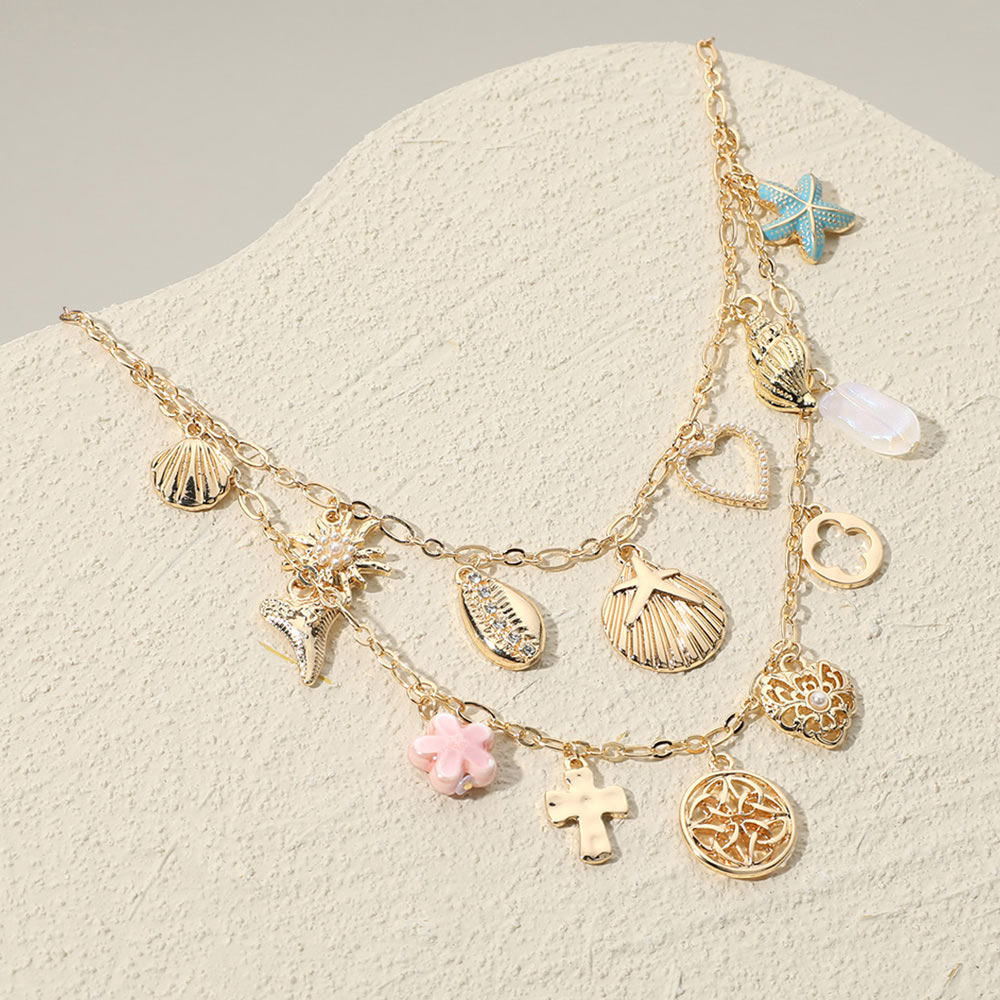 Madeline Love Gold, Multi Sea Shell Puka Shell Cross Quatrefoil Stone Pearl Heart Ceramic Flower Charm Station Double Layered Necklace - Necklaces
