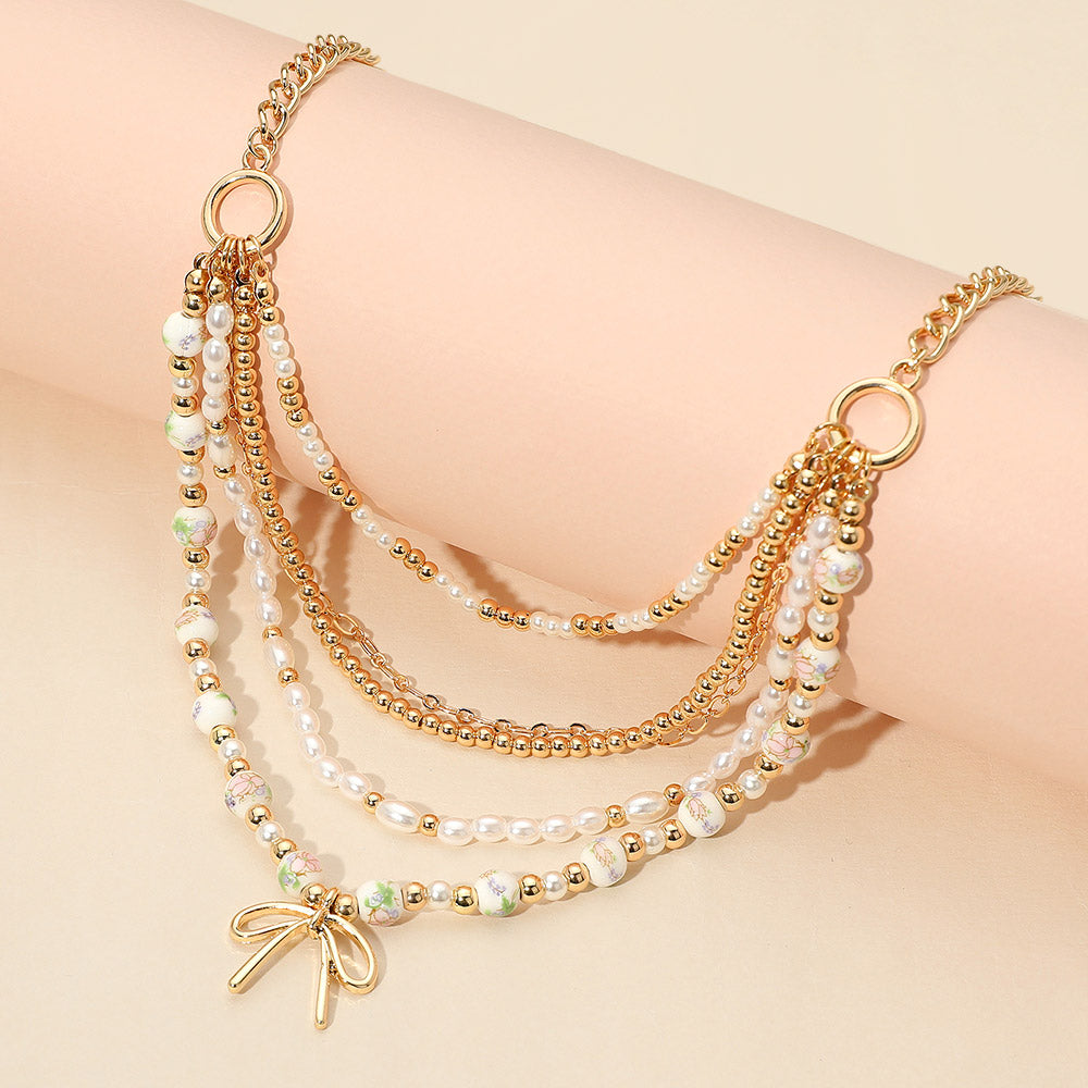 Madeline Love Gold, Pink Metal Bow Pendant Floral Ceramic Ball Pearl Beaded Multi Layered Necklace