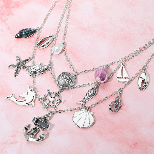 Madeline Love Antique Rhodium, Multi Anchor Sea Shell Pearl Dolphin Fish Rope Sea Turtle Charm Embellished Triple Layered Necklace - Necklaces