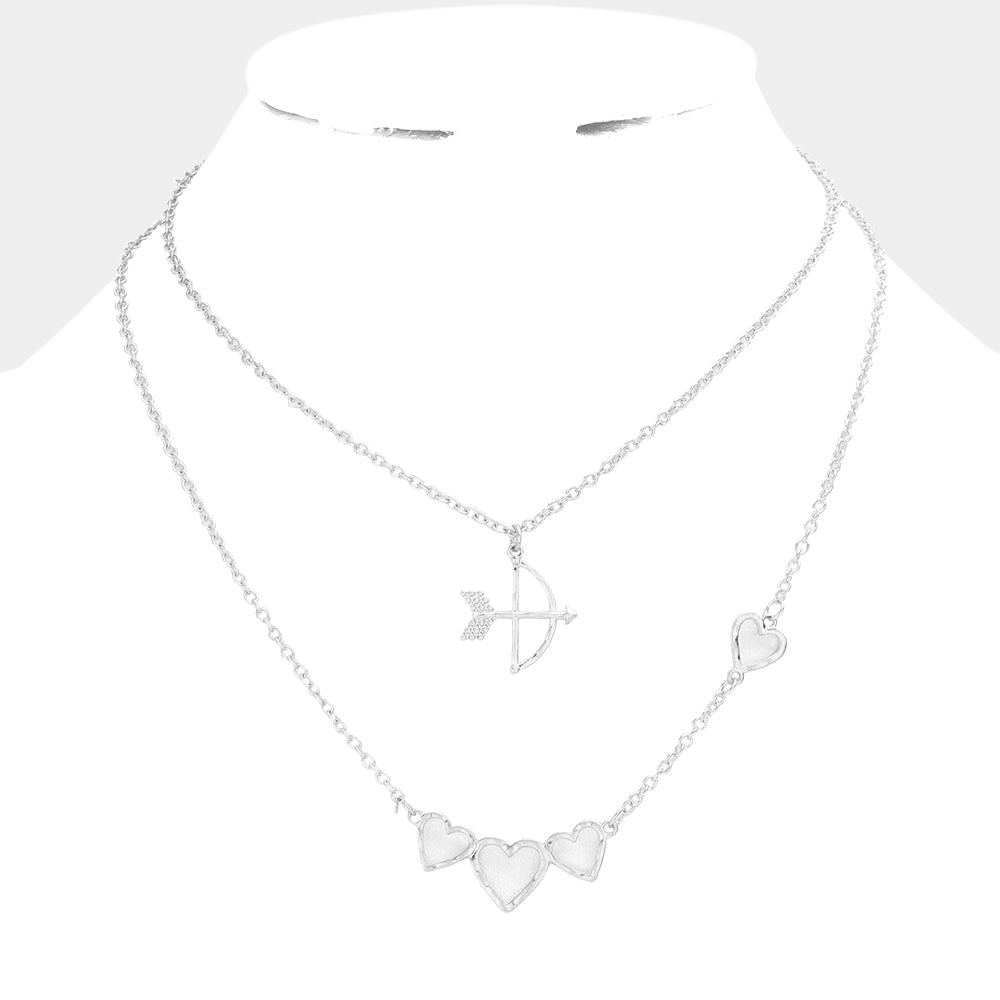 Worn Gold 2-piece set of Cupid's Arrow Heart Pendant Necklaces is the perfect romantic gift. Crafted with delicate detail, the pendants feature intertwined arrows and hearts, symbolising a deep and everlasting love. Made from high-quality materials, these necklaces are both stylish and durable. Give the gift of love with this jewelry set.