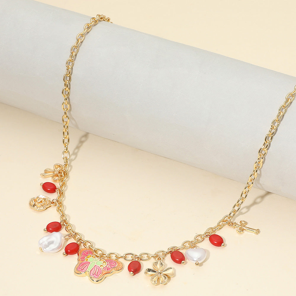 Madeline Love Gold, Red Enamel Butterfly Flower Cross Bow Heart Pearl Charm Station Necklace - Necklaces
