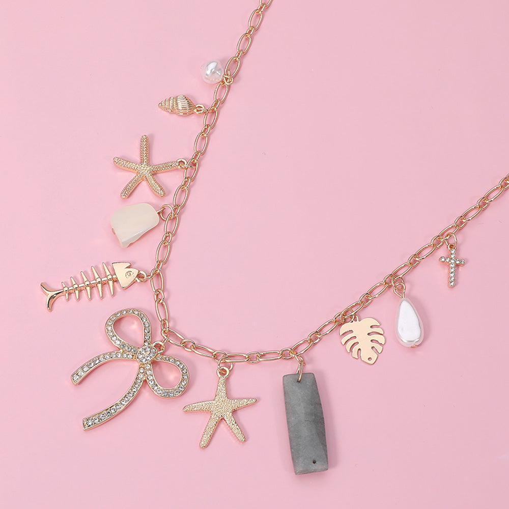 Madeline Love Clear, Gold Stone Paved Bow Metal Starfish Fish Shell Pearl Tropical Leaf Charm Station Necklace - Necklaces
