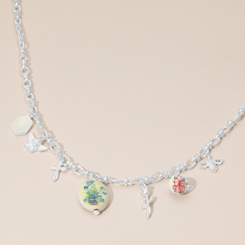 Madeline Love Green, Matte Silver Vintage Floral Ceramic Charm Metal Angel Flower Stem Honey Bee Charm Station Necklace - Necklaces