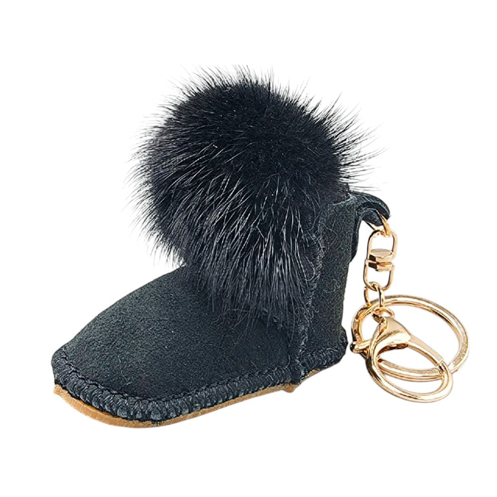 black Faux Fur Pom Pom Boot Bag Charm adds a playful touch to boots, bags, and other accessories. The durable clasp ensures secure attachment, making it a versatile and stylish addition to your everyday look. Perfect for those who love fun and trendy accessories.