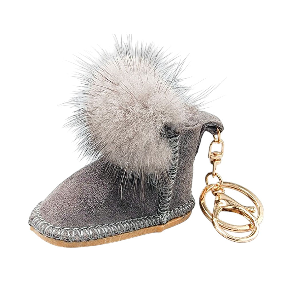 Grey Faux Fur Pom Pom Boot Bag Charm adds a playful touch to boots, bags, and other accessories. The durable clasp ensures secure attachment, making it a versatile and stylish addition to your everyday look. Perfect for those who love fun and trendy accessories.