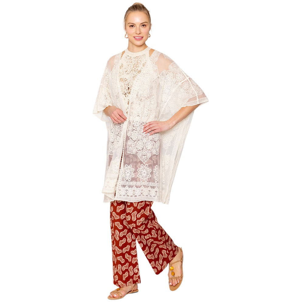 Ivory Flower Lace Kimono Poncho is a versatile and fashionable addition to any wardrobe. The delicate lace detailing adds a touch of elegance, while the kimono style allows for comfortable and easy wear. Perfect for dressing up any outfit, this poncho is a must-have for any fashion-forward individual. 