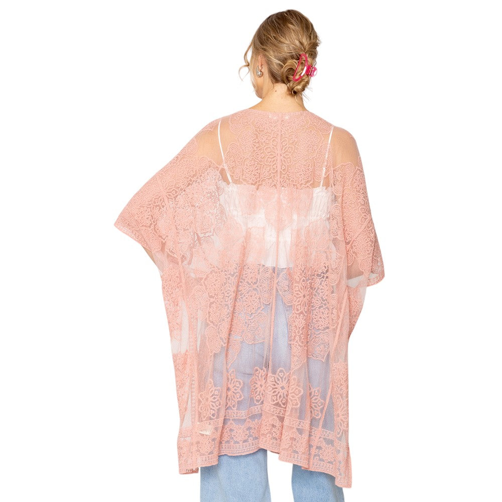 Pink Flower Lace Kimono Poncho is a versatile and fashionable addition to any wardrobe. The delicate lace detailing adds a touch of elegance, while the kimono style allows for comfortable and easy wear. Perfect for dressing up any outfit, this poncho is a must-have for any fashion-forward individual. 