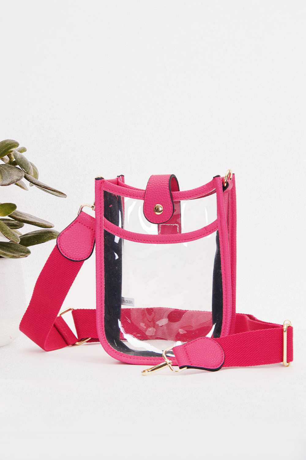 Fuchisia Perfect for concert season and stadium events, this clear crossbody mini bag meets all venue security requirements while keeping your essentials within reach. Crafted from durable 100% PVC, it's easy to clean and built to last through countless outings. Compact yet functional at 8" x 5.8" x 2.3", the adjustable crossbody strap sits comfortably across your body, leaving your hands free. The transparent design lets you quickly locate your phone, keys, and small valuables at a glance.