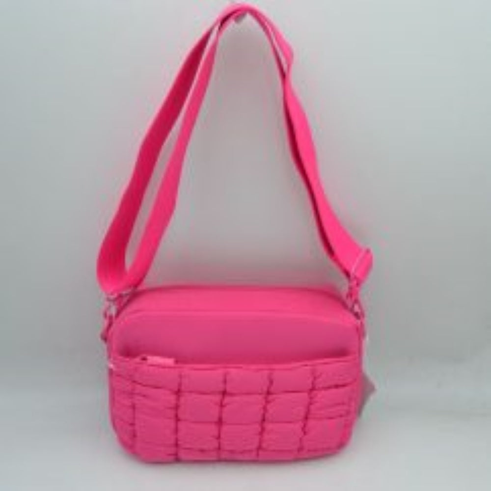 Fuchsia This practical crossbody bag is designed for effortless everyday use, featuring a distinct quilted pattern across the lower front section. It offers multiple storage compartments, including a secure main zippered closure and an easily accessible front slip pocket to organize your daily essentials. A wide, adjustable shoulder strap ensures comfortable, customizable carrying, making it a perfect accessory for hands-free convenience while on the go.
