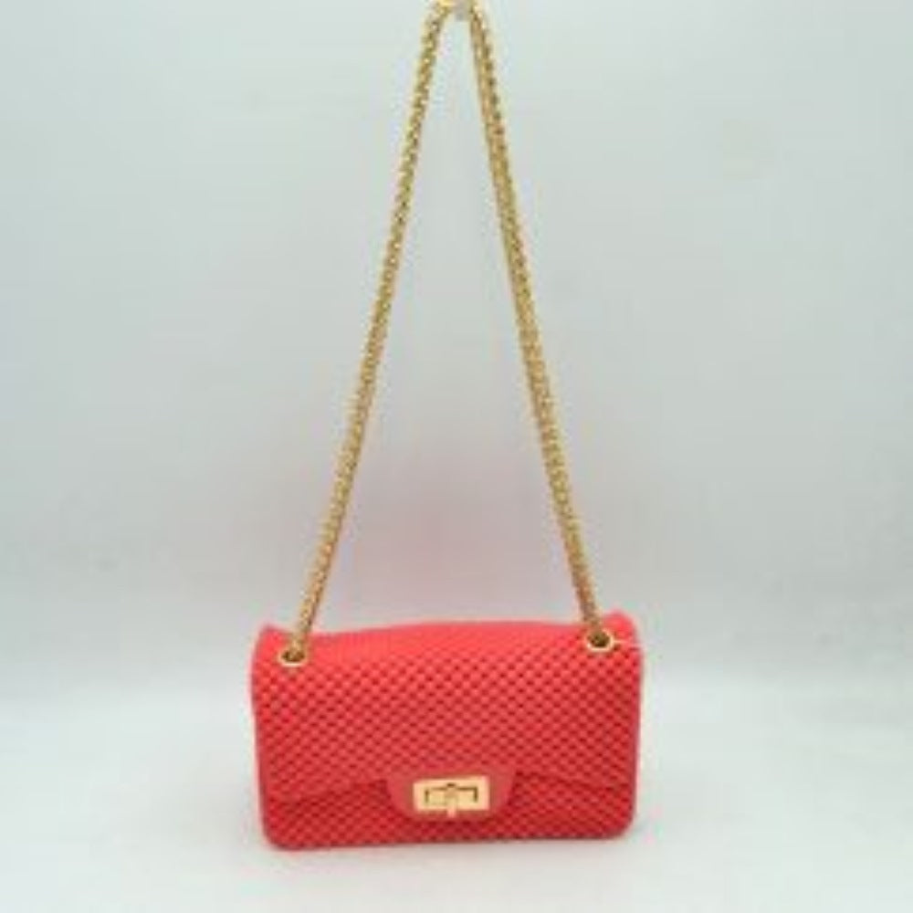 Fuchsia This rectangular flap bag showcases a distinctive all-over bumpy textured design that adds unique tactile interest, making it a stylish choice for everyday use. The main storage compartment is safely secured by a front flap featuring a metallic twist-lock closure. Designed for easy carrying, the bag incorporates a long metallic chain shoulder strap fed through top eyelets, allowing it to rest comfortably on the shoulder throughout the day.