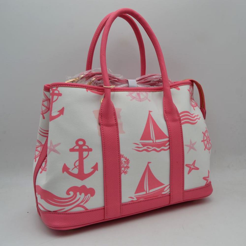 Fuchsia Set sail with this nautical-inspired canvas tote. Featuring a crisp backdrop decorated with a classic print of anchors, sailboats, ship wheels, and ocean waves, this bag is the perfect accessory for coastal getaways or adding maritime flair to your daily ensemble. Framed with structured textured trim, it balances casual resort style with sharp, everyday functionality.