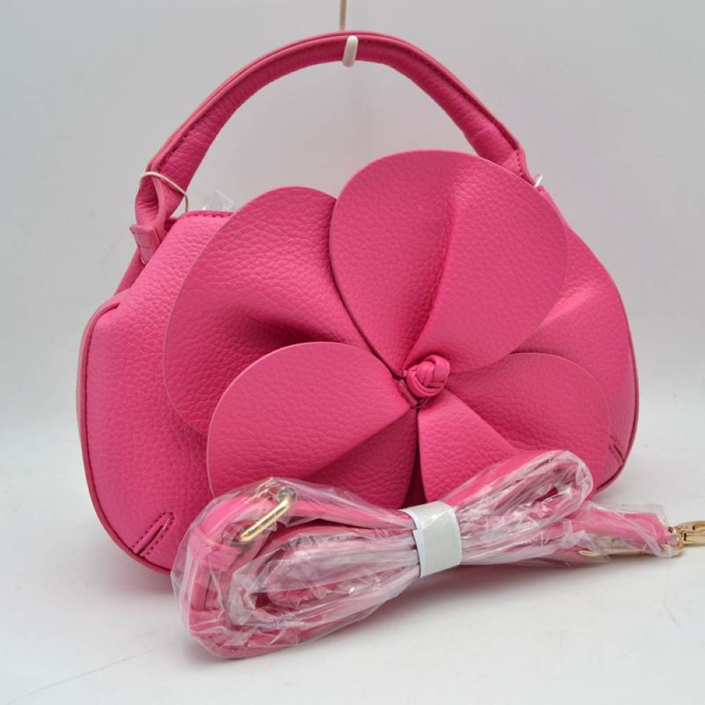 Fuchsia Make a striking fashion statement with this avant-garde pebble-grain handbag. Defined by its dramatic, oversized three-dimensional leather flower overlay on the front panel, this unique bag effortlessly bridges the gap between modern sculptural art and functional everyday luxury.