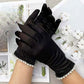 Black Elegant satin-style gloves featuring delicate lace and pearl trim at the cuffs. A refined accessory ideal for formal events, evening wear, or special occasions. Comfortable and stylish for a polished finish.