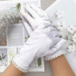 White Elegant satin-style gloves featuring delicate lace and pearl trim at the cuffs. A refined accessory ideal for formal events, evening wear, or special occasions. Comfortable and stylish for a polished finish.