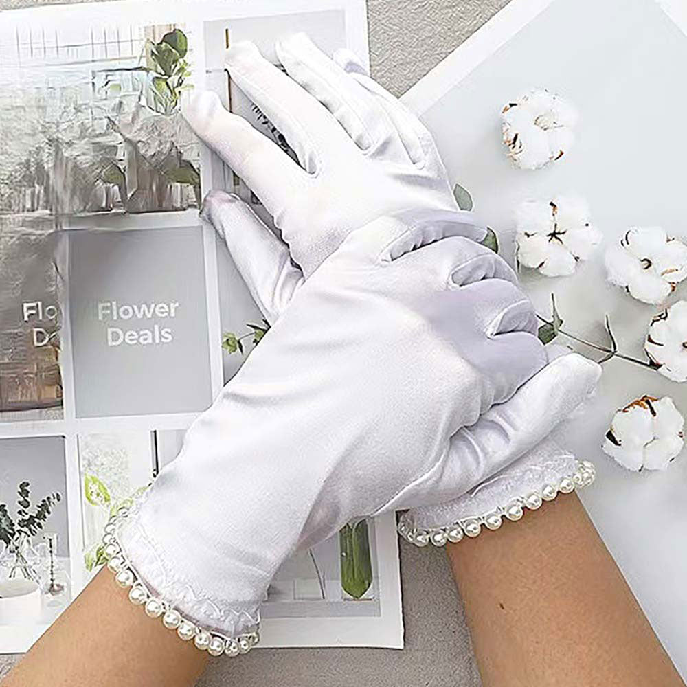White Elegant satin-style gloves featuring delicate lace and pearl trim at the cuffs. A refined accessory ideal for formal events, evening wear, or special occasions. Comfortable and stylish for a polished finish.