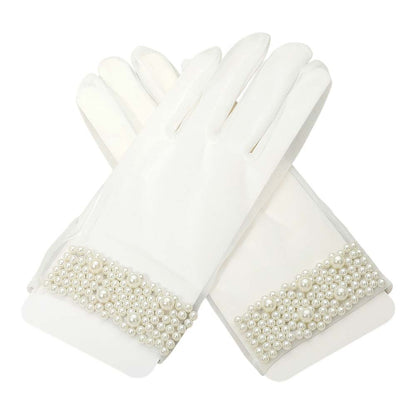 White Refined gloves adorned with clustered pearl accents at the cuff, ideal for formal events, bridal wear, or vintage-inspired looks. These elegant accessories provide a sophisticated finish to your outfit.