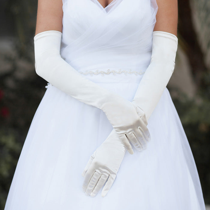Ivory Dressy Satin Long Wedding Gloves feature a smooth, lustrous finish that adds timeless elegance to bridal and formal ensembles. Designed for a comfortable long fit, they provide a polished look while allowing ease of movement throughout your special occasion.