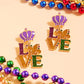 Glittered Enamel Mardi Gras LOVE Message Dangle Earrings are the perfect accessory for any Mardi Gras celebration. The glittered enamel adds a subtle sparkle, while the dangle design creates a playful, eye-catching look. Show your love for Mardi Gras in style with these vibrant earrings.