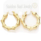 Gold 18K Gold Dipped Stainless Steel 1.5 Inch Metal Bamboo Hoop Earrings are expertly crafted using high-quality materials to provide a luxurious and durable accessory. The gold dipping process ensures a glossy finish and the 1.5-inch diameter adds a touch of elegance to any outfit.