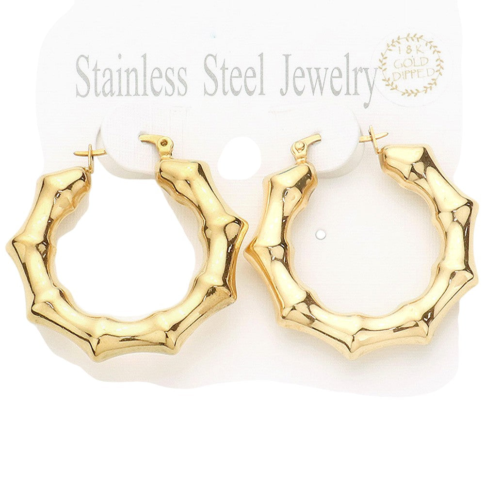 Gold 18K Gold Dipped Stainless Steel 1.5 Inch Metal Bamboo Hoop Earrings are expertly crafted using high-quality materials to provide a luxurious and durable accessory. The gold dipping process ensures a glossy finish and the 1.5-inch diameter adds a touch of elegance to any outfit.