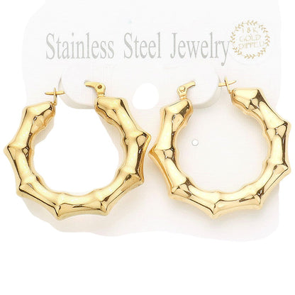 Gold 18K Gold Dipped Stainless Steel 1.5 Inch Metal Bamboo Hoop Earrings are expertly crafted using high-quality materials to provide a luxurious and durable accessory. The gold dipping process ensures a glossy finish and the 1.5-inch diameter adds a touch of elegance to any outfit.