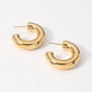 Gold 18K Gold Dipped Stainless Steel Chunky Hoop Earrings. Made with high-quality stainless steel and dipped in 18K gold, these earrings are durable and stylish. Add a touch of elegance to any outfit with these classic chunky hoops. Perfect for any occasion, these earrings are a must-have addition to your jewelry collection.