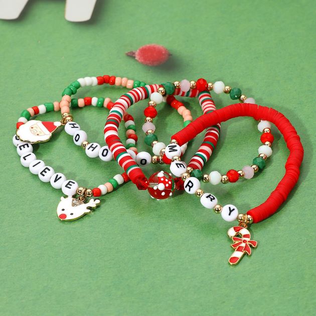 Playful holiday coil bracelet set with colorful beads, festive charms including Santa, reindeer, candy cane, and Merry letters. A fun accessory to celebrate Christmas style and perfect for holiday gifting.