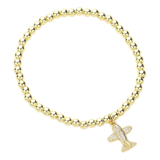 Gold CZ stone paved airplane charm bracelet is designed with stainless steel and ball beads for a durable and elegant look. The stretch design allows for a comfortable fit. Perfect for any aviation enthusiast, this bracelet adds a touch of glamour to any outfit.