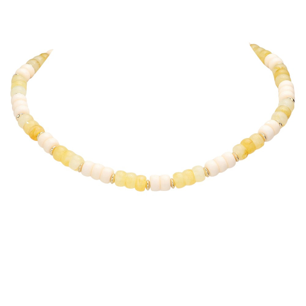 Gold Ivory Chunky Beaded Necklace is a versatile and stylish accessory for any outfit. Made with chunky beads, it adds a touch of elegance and texture to your look. Its bold design makes a statement while being comfortable to wear. Elevate your fashion sense with this eye-catching necklace.