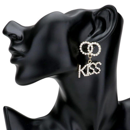 Gold KISS Rhinestone Embellished Message Dangle Earrings are the perfect accessory to add a touch of glamour to any outfit. The delicate dangle design adds movement and sparkle to your look, making you stand out from the crowd. Own these stunning earrings and shine like a star.