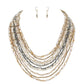 Gold Multi Beaded Strand Necklace is the perfect accessory for any outfit. The multiple strands of beads add texture and dimension, creating a unique and eye-catching piece. With its versatile design, it can easily be dressed up or down, making it a must-have for any jewelry collection.