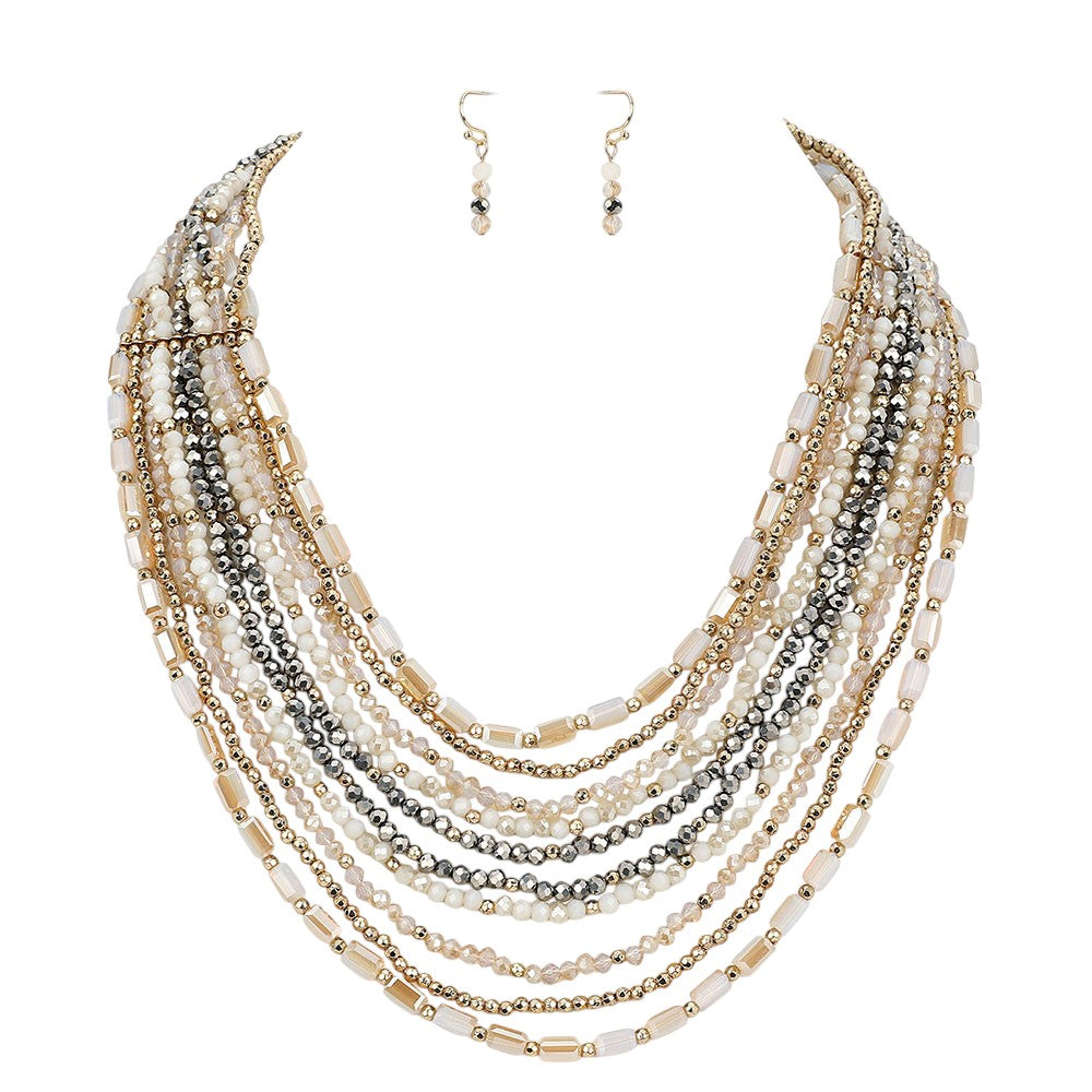 Gold Multi Beaded Strand Necklace is the perfect accessory for any outfit. The multiple strands of beads add texture and dimension, creating a unique and eye-catching piece. With its versatile design, it can easily be dressed up or down, making it a must-have for any jewelry collection.