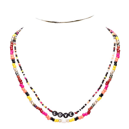 Gold Multi Color Bead Statement Love Layered Necklace adds a pop of color to any outfit! The multi-layered design and vibrant beads create a unique statement piece that is sure to catch attention. Elevate your style with this eye-catching necklace.