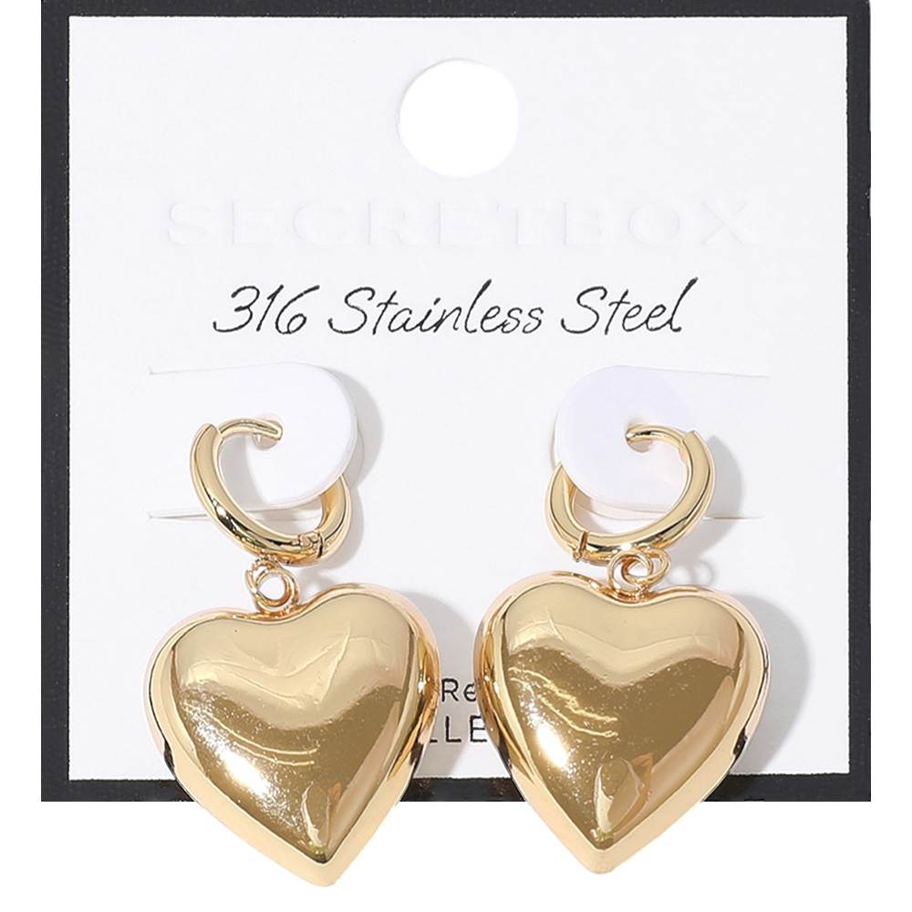 Gold SECRET BOX Stainless Steel Heart Dangle Huggie Hoop Earrings are expertly crafted with high-quality stainless steel for durability and long-lasting wear. The elegant heart dangle adds a touch of romance, while the secure huggie hoop design ensures comfortable and easy wear. Elevate any outfit with these stylish and timeless earrings.