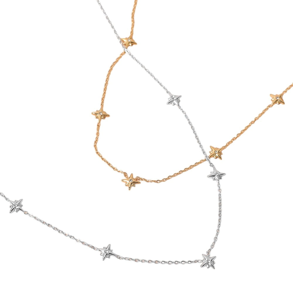 Gold SECRET BOX Stainless Steel Stone Starburst Station Necklace is a stunning piece of jewelry that will elevate any outfit. Made with high-quality stainless steel, it is durable and long-lasting. The unique starburst design with sparkling stones adds a touch of elegance and sophistication. Perfect for any occasion. 