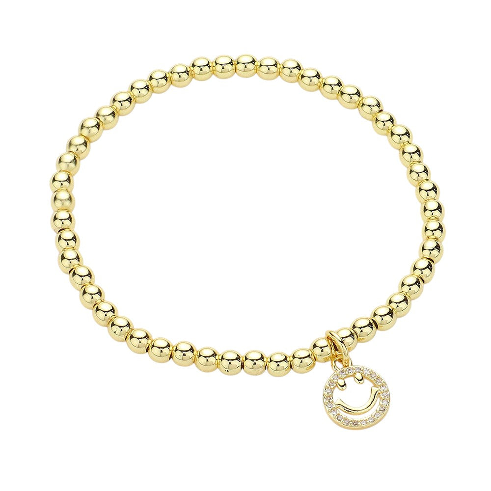 Gold Stainless Steel Stone Paved Smile Emoji Charm Stretch Ball Bracelet is a unique and stylish accessory that adds a touch of fun and playfulness to any outfit. Made with high-quality stainless steel and adorned with a stone paved smile emoji charm, this stretch bracelet is not only durable but also eye-catching. Complete your look with a smile, and get ready to receive compliments.