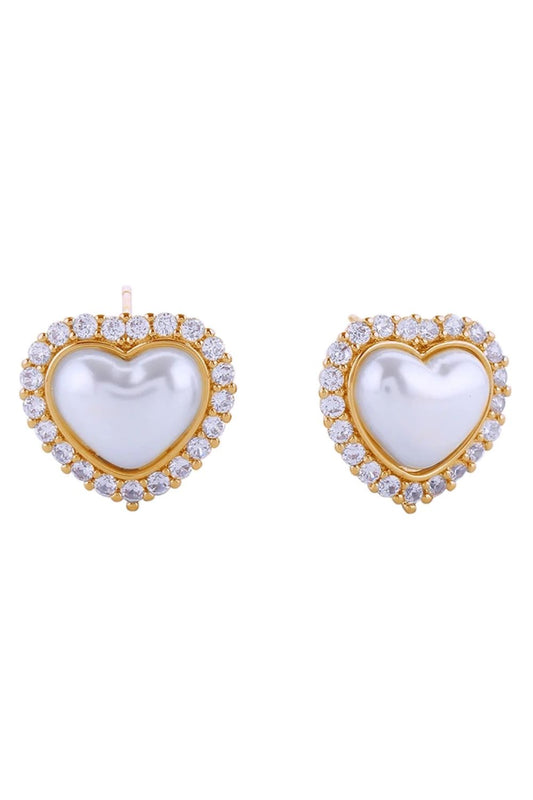 Gold Elegant heart-shaped post earrings featuring lustrous pearls accented with sparkling cubic zirconia pavé detailing. Crafted from hypoallergenic brass with 14K gold or white gold dipping for a luxurious finish. Measuring 1.8cm in diameter, these versatile studs complement any occasion. Lead and nickel compliant for sensitive skin. Made in Korea with quality craftsmanship.