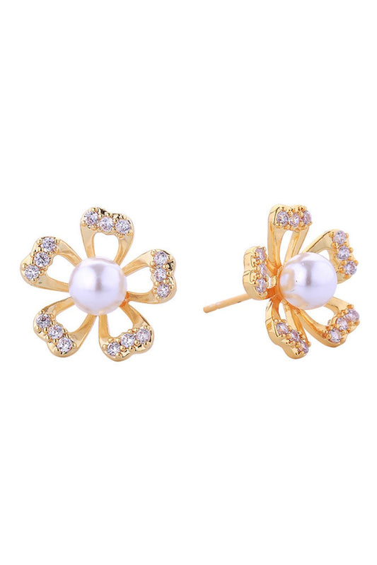 Gold Timeless pearl post earrings with delicate gold and white dipped petal detailing. Each piece combines lustrous pearls with sparkling cubic zirconia accents, set in hypoallergenic brass for sensitive ears. At 1.7cm diameter, they strike the perfect balance between statement and subtlety. Lead and nickel compliant for peace of mind. Ideal for layering or wearing solo, these versatile studs transition seamlessly from day to evening.