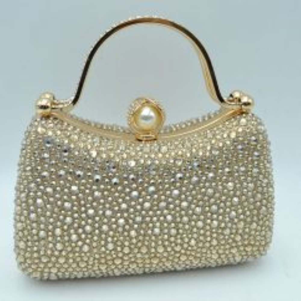 Gold This elegant evening clutch bag features a structured silhouette heavily encrusted with shimmering black rhinestones, offering a highly textured and glamorous look for formal events. A sleek, curved metallic top handle lined with delicate crystals rises over the frame for a secure grip, anchored by polished spherical accents. The secure metal frame is highlighted by a prominent decorative clasp featuring a large faux pearl wrapped in rhinestone-studded detailing