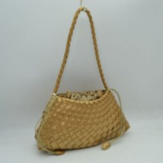 Gold This structural shoulder bag showcases an intricate woven pattern across its main body in a shimmering metallic gold tone, creating a highly textured and elegant silhouette. It features a single slim, braided shoulder strap attached securely to the upper corners for a comfortable drop. The main storage compartment is designed with an inner fabric lining that gathers tightly via a cinch drawstring closure, accented by long side cords finished with smooth