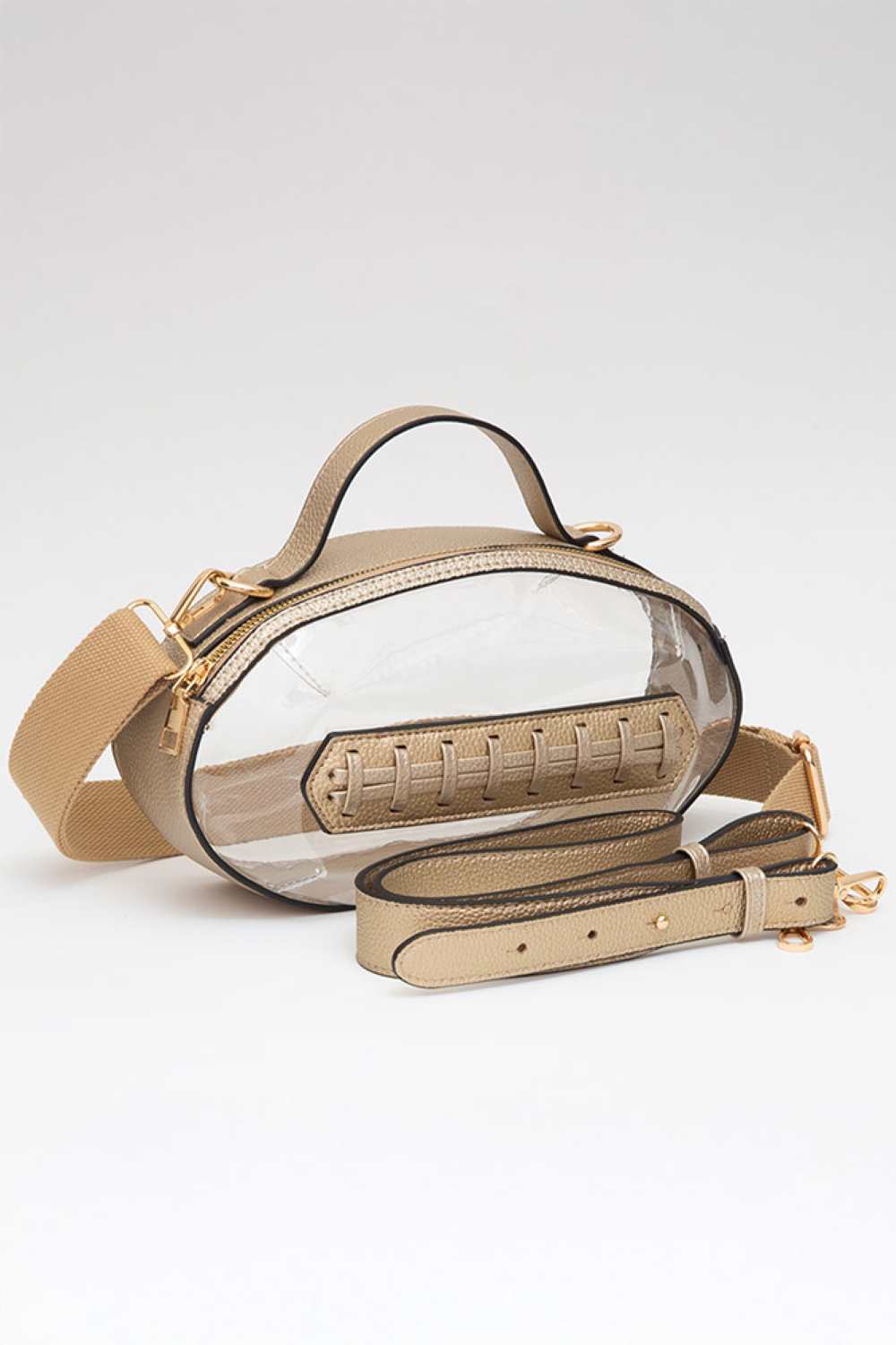 Gold Carry your essentials in style with this unique football-shaped transparent crossbody bag. Perfect for stadium events, concerts, and outdoor gatherings, the clear PVC design lets you see everything inside while meeting venue security requirements. Measuring 11" x 6" x 4", it offers practical storage without bulk. The adjustable crossbody strap keeps your hands free, making it ideal for busy days out. Durable 100% PVC construction ensures long-lasting wear through countless adventures.
