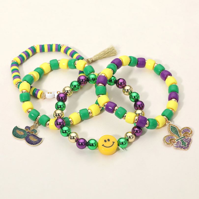 Gold Green Purple Yellow This Mardi Gras charm beaded stretch bracelet set features playful bead designs accented with festive charms and fun focal details. Designed for comfortable stretch wear, each bracelet can be styled alone or stacked together, making it ideal for celebrations, themed events, party favors, and eye-catching seasonal accessory displays.
