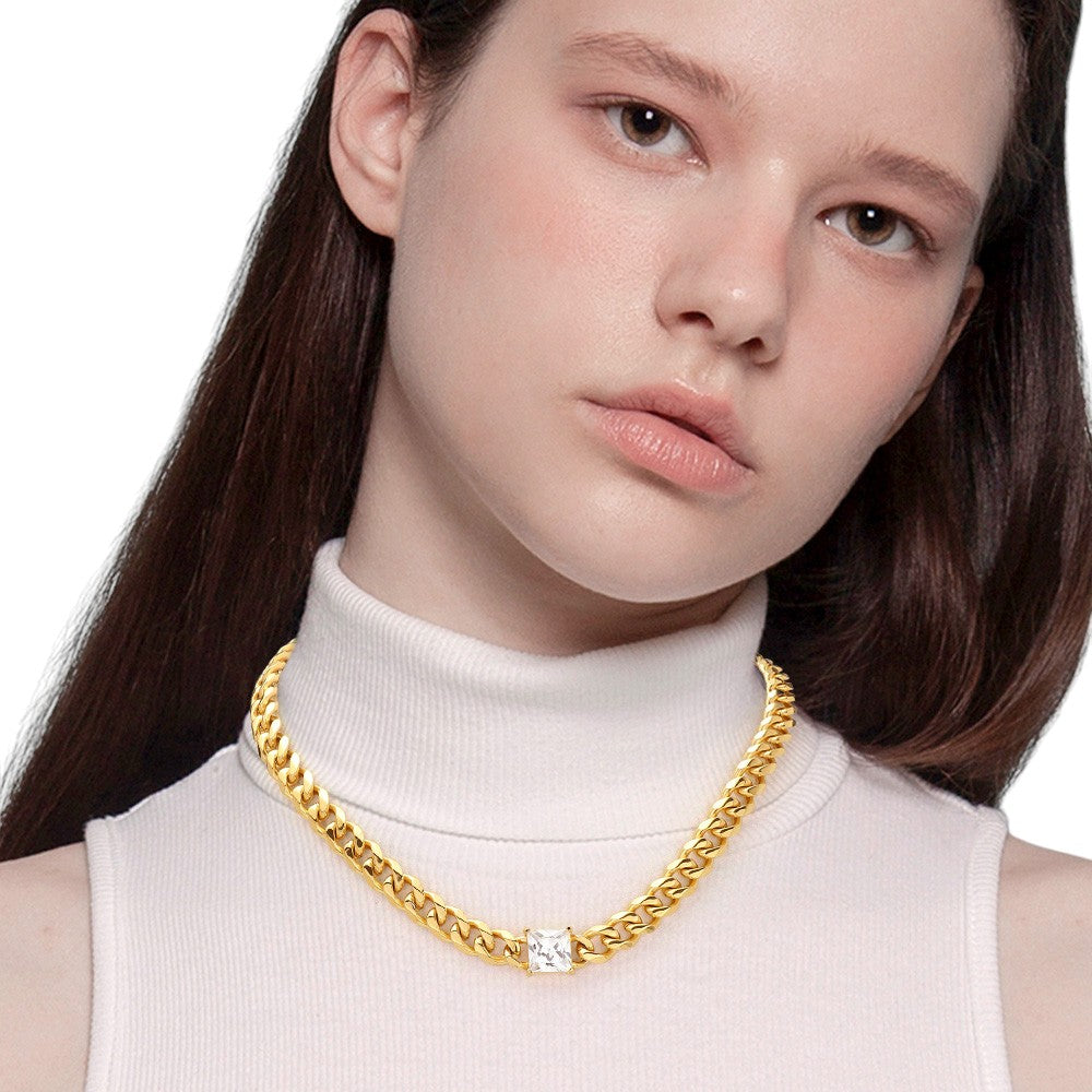 Gold 18K Gold Dipped Stainless Steel CZ Square Stone Accented Necklace features high-quality stainless steel dipped in 18K gold, adorned with a beautifully sparkling CZ square stone. Crafted with precision and durability, this elegant necklace is perfect for any occasion. Enjoy the luxurious shine of gold and the lasting strength of stainless steel, making it a timeless addition to your collection. 